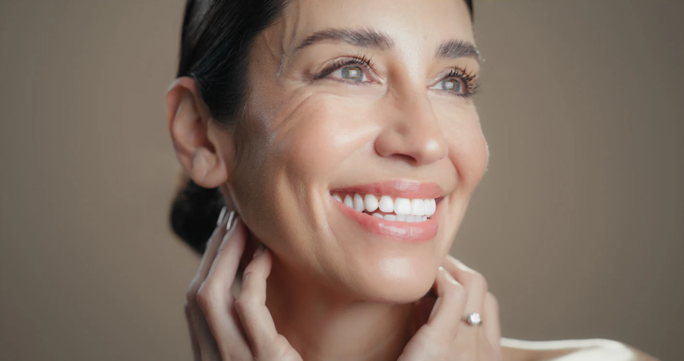 A smiling woman in soft, natural light