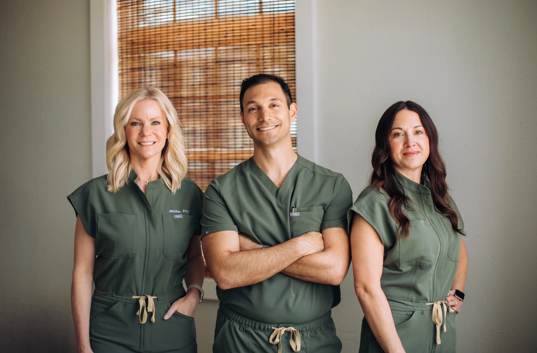 Dr. Corey with two members of the Summit care team in green scrubs